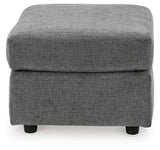 Ashley Furniture Stairatt Ottoman with plush fabric and wooden legs, showcasing its versatile, modern design.