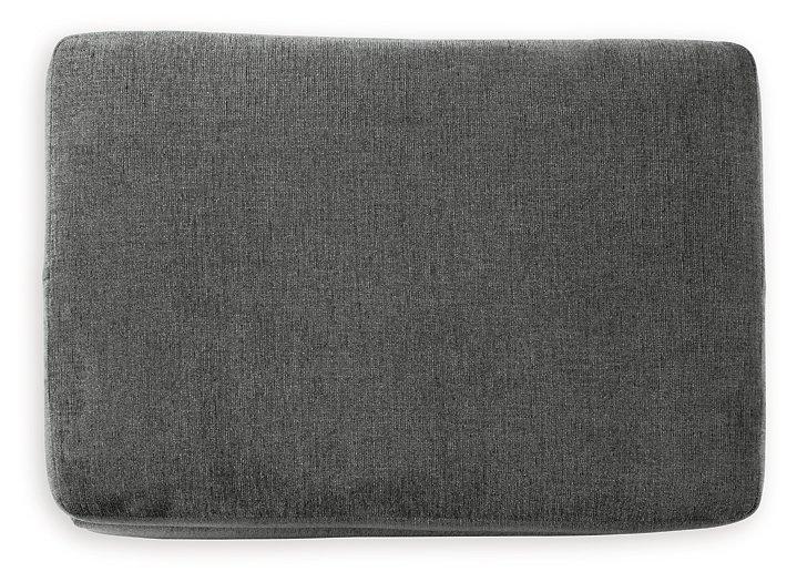 Ashley Furniture Stairatt Ottoman with plush fabric and storage space, shown in a modern living room setting.
