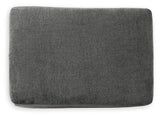 Ashley Furniture Stairatt Ottoman with plush fabric and storage space, shown in a modern living room setting.