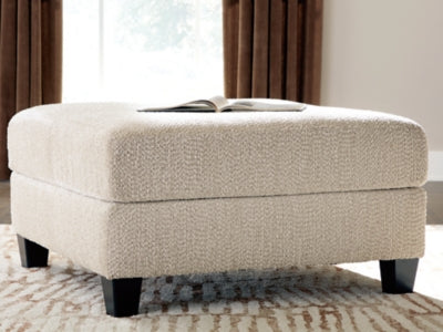 Ashley Furniture Steelwater Retreat oversized accent ottoman with plush fabric and sturdy wooden legs, suitable for living room decor.