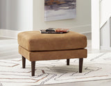 Ashley Furniture Telora Ottoman with plush fabric and wooden legs, showcasing its stylish and comfortable design.