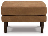 Ashley Furniture Telora Ottoman with plush fabric and wooden legs, shown in a cozy living room setting.
