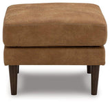 Ashley Furniture Telora Ottoman showing a plush fabric surface and sturdy wooden legs in a modern living room setting