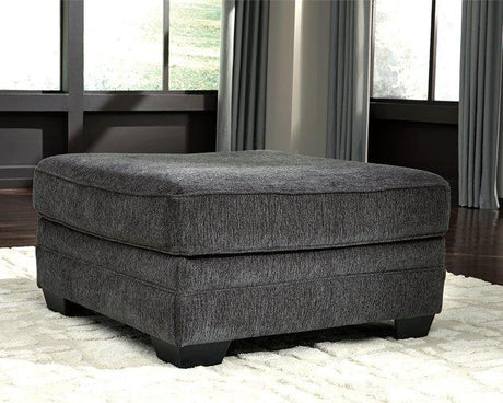 Oversized Ashley Furniture Tracling Ottoman with soft fabric upholstery and plush cushioning on a modern living room floor.