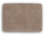 Ashley Furniture Triston-Peaks Ottoman with plush fabric and wooden legs, shown from a top view.