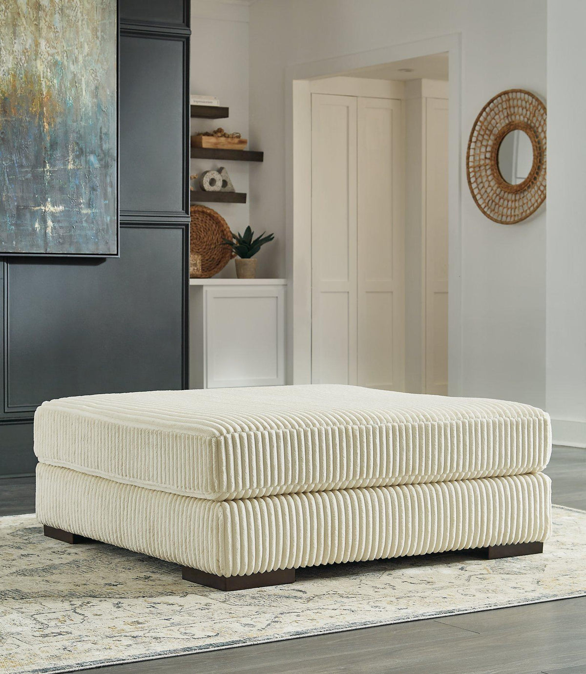 Ashley Furniture Lindyn oversized accent ottoman with soft fabric upholstery and plush cushioning in a neutral color.