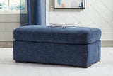 Ashley Furniture Evansley Ottoman in beige fabric with wooden legs, showcasing a plush, versatile storage and seating solution.