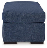 Ashley Furniture Evansley Ottoman with plush fabric and wooden legs, perfect for living room decor and added seating.