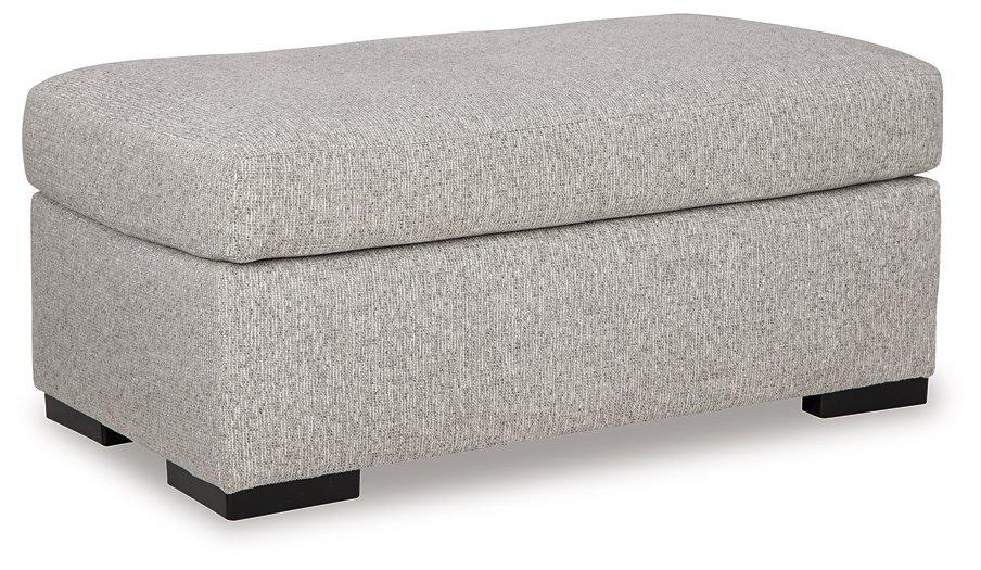 Ashley Furniture Evansley Ottoman showing a plush fabric surface with wooden legs, perfect for living room or seating area.