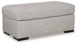 Ashley Furniture Evansley Ottoman showing a plush fabric surface with wooden legs, perfect for living room or seating area.