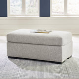 Ashley Furniture Evansley Ottoman with soft fabric upholstery and wooden legs, showcasing a stylish and functional accent piece.