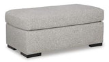 Ashley Furniture Evansley Ottoman, upholstered fabric with tufted top, serving as a stylish storage and seating piece.
