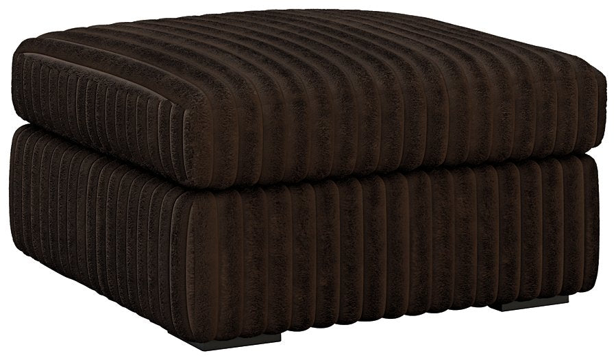 Ashley Furniture Midnight-Madness oversized accent ottoman with plush fabric and modern design, shown from an angled side view.