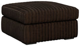 Ashley Furniture Midnight-Madness oversized accent ottoman with plush fabric and modern design, shown from an angled side view.