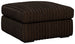 Ashley Furniture Midnight-Madness oversized accent ottoman with plush fabric and modern design, shown from an angled side view.