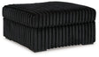 Oversized Midnight-Madness accent ottoman by Ashley Furniture with plush fabric and modern design, suitable for living rooms or seating areas.