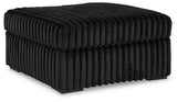 Oversized Midnight-Madness accent ottoman by Ashley Furniture with plush fabric and modern design, suitable for living rooms or seating areas.