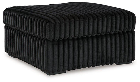 Oversized Midnight-Madness accent ottoman by Ashley Furniture with plush fabric and modern design, suitable for living rooms or seating areas.