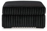 Oversized Ashley Furniture Midnight-Madness accent ottoman with plush fabric and modern design, perfect as a stylish living room piece.