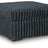 Ashley Furniture Midnight-Madness oversized accent ottoman with plush fabric and sturdy wooden legs, shown from an angled view.