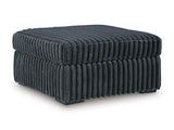 Ashley Furniture Midnight-Madness oversized accent ottoman with a plush fabric cover and stylish design, viewed from an angled perspective.