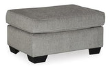 Ashley Furniture Altari Ottoman in neutral fabric with tufted top and wooden block legs, ideal as a versatile living room accent piece.