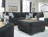 Ashley Furniture Altari oversized accent ottoman with plush fabric and sturdy wooden legs, perfect for living room decor.