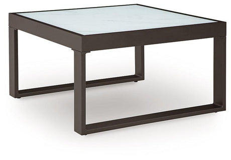 Outdoor Ashley Furniture Beachloft outdoor coffee table with a modern design, perfect for outdoor cocktail gatherings.