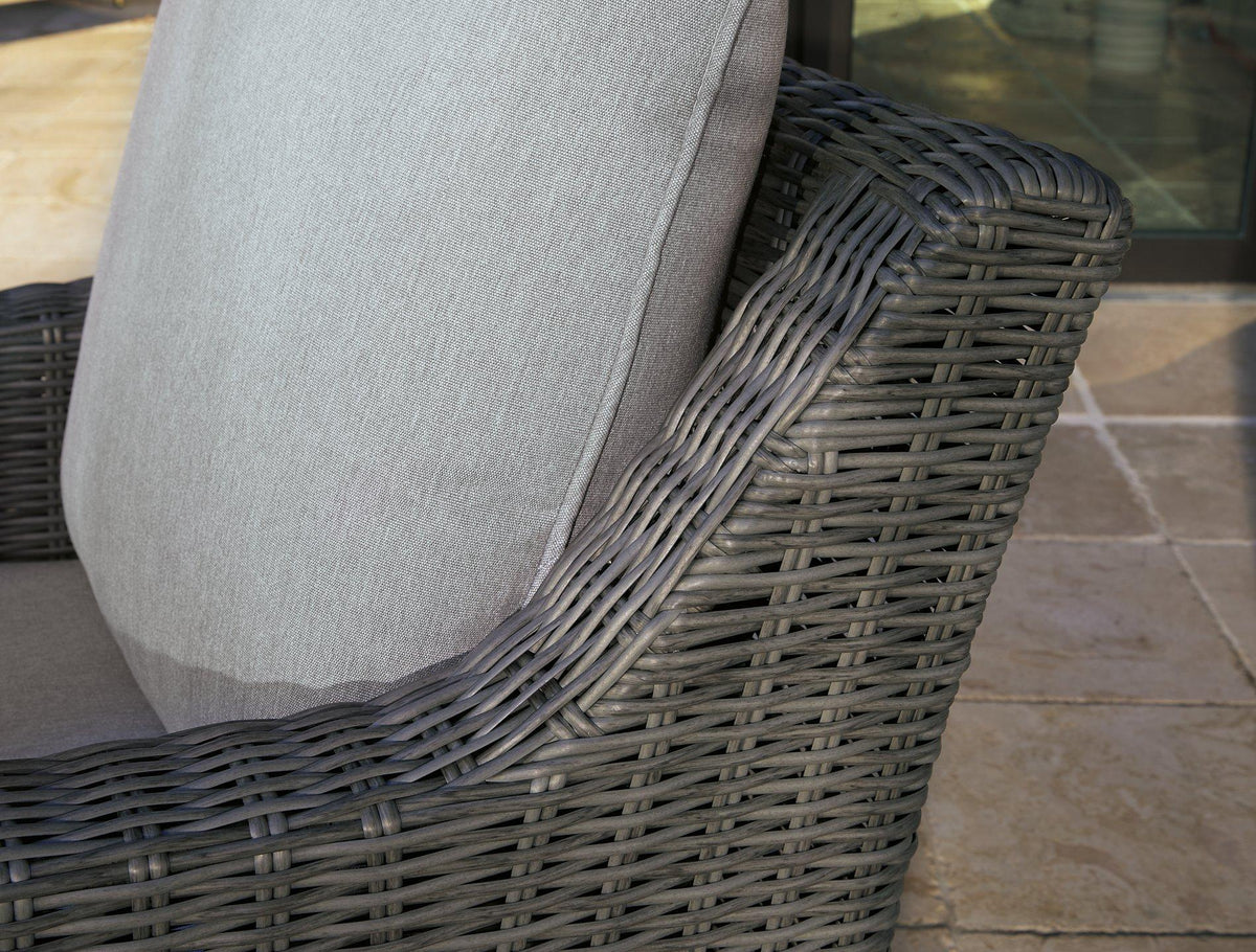 Outdoor swivel lounge chair with cushion by Ashley Furniture, featuring a stylish metal frame and comfortable seating for outdoor relaxation.