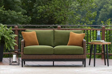 Outdoor loveseat with cushions from Ashley Furniture's Horizon Hall collection, featuring a stylish metal frame and comfortable seating.