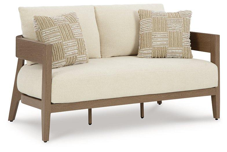 Ashley Furniture Serene Bay outdoor loveseat with cushioned seating and sturdy frame, perfect for patio relaxation.