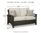 Ashley Furniture Shoreside outdoor loveseat with plush cushions and weather-resistant frame, perfect for patio relaxation.