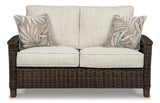 Outdoor loveseat by Ashley Furniture featuring cushioned seating and a sturdy metal frame for patio relaxation.