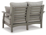 Ashley Furniture Visola outdoor loveseat with matching cushion, featuring woven rattan-style frame and plush seating for outdoor relaxation.