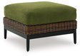 Outdoor ottoman with cushion from Ashley Furniture's Horizon Hall collection, shown from an angled side view.