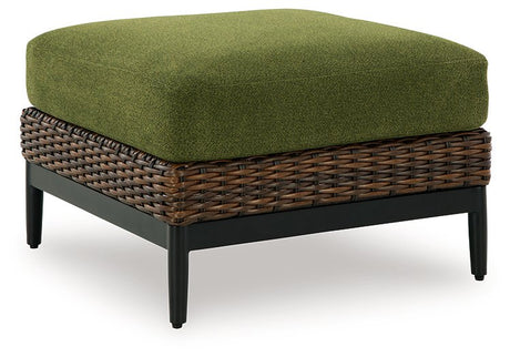 Outdoor ottoman with cushion from Ashley Furniture's Horizon Hall collection, shown from an angled side view.