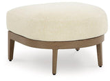 Outdoor Ashley Furniture Serene Bay ottoman with cushion, featuring woven design and plush seating for outdoor relaxation.