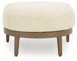 Outdoor Ashley Furniture Serene Bay Ottoman with cushion, featuring woven design and plush seating for outdoor relaxation.