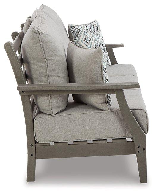 Ashley Furniture Visola outdoor sofa with plush cushions, featuring weather-resistant outdoor seating for patio relaxation.