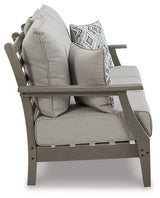 Ashley Furniture Visola outdoor sofa with plush cushions, featuring weather-resistant outdoor seating for patio relaxation.