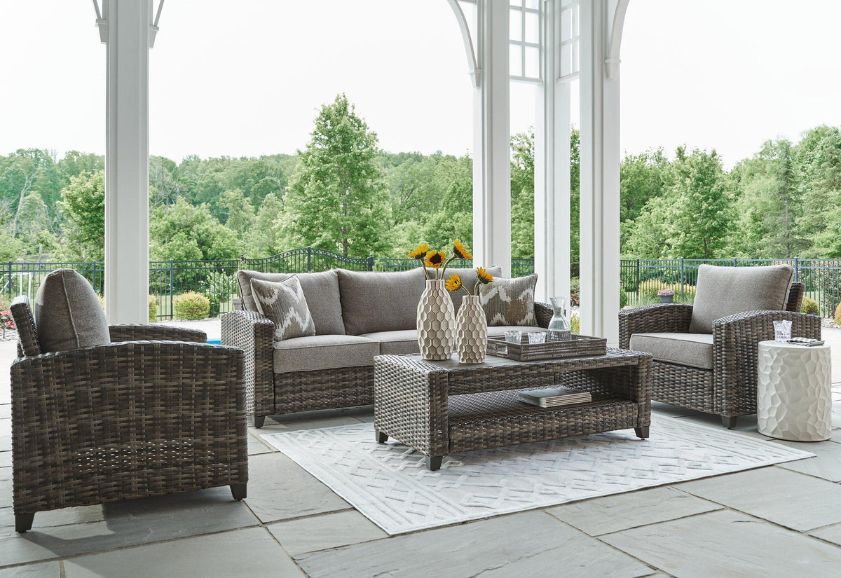 Outdoor Oasis Court furniture set by Ashley Furniture with sofa, chairs, and table for stylish outdoor seating.