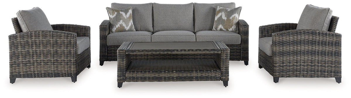 Outdoor patio set with sofa, chairs, and table from Ashley Furniture's Oasis Court outdoor seating collection.