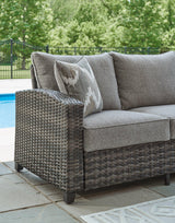 Ashley Furniture Oasis Court outdoor sofa, chairs, and table set with cushioned seating and sturdy frame for patio relaxation.