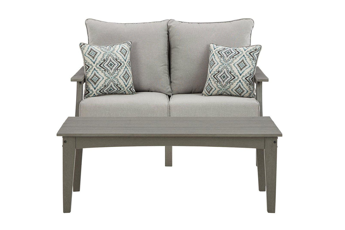 Outdoor Ashley Furniture Visola loveseat and coffee table set with cushioned seats and a wooden table, ideal for patio relaxation.