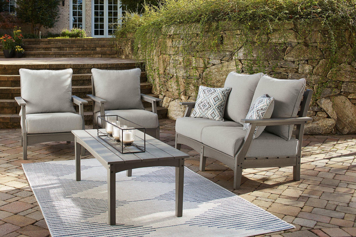 Ashley Furniture Visola outdoor loveseat and conversation set with cushioned seats and weather-resistant wicker design.