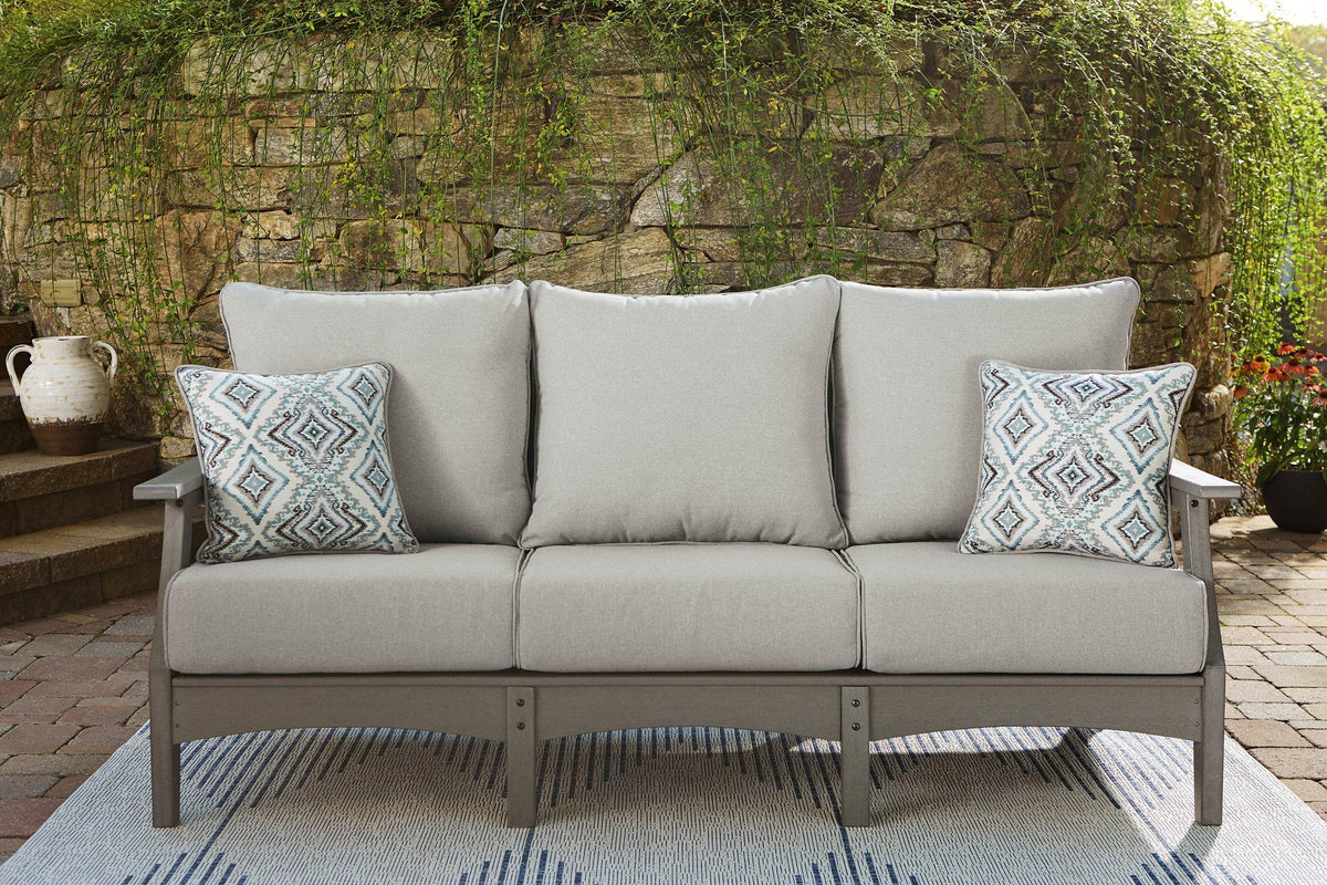 Outdoor seating set featuring Ashley Furniture Visola sofa, loveseat, and coffee table with weather-resistant cushions and modern design.