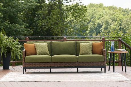 Ashley Furniture Horizon Hall outdoor sofa with cushions, featuring woven rattan design and plush seating for outdoor relaxation.