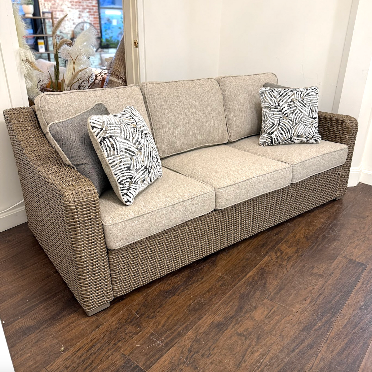 Ashley Furniture Seacoast outdoor sofa with plush cushions, stylish design, perfect for outdoor living spaces.