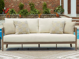 Outdoor sofa with cushions from Ashley Furniture, featuring a stylish design perfect for outdoor lounging.