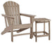 Outdoor table set by Ashley Furniture featuring a glass-top table and matching chairs in a sunny outdoor setting.